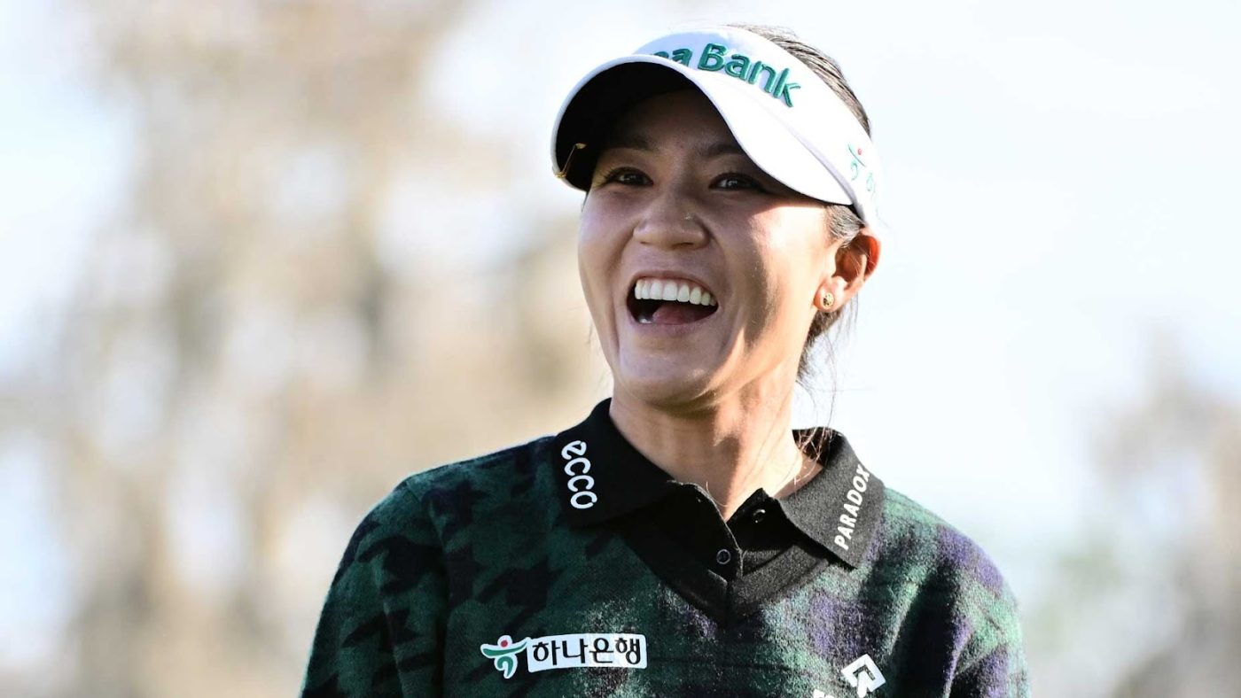 lydia ko smiles in celebration wearing black shirt and white visor